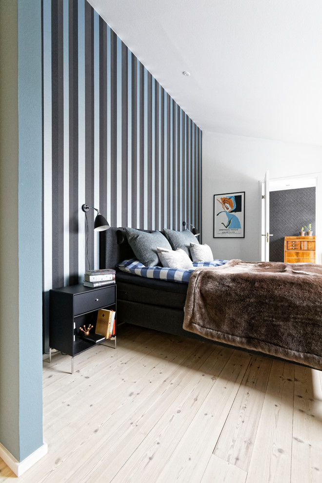 Design ideas for a contemporary bedroom in Copenhagen with multi-coloured walls, light hardwood flooring and beige floors.