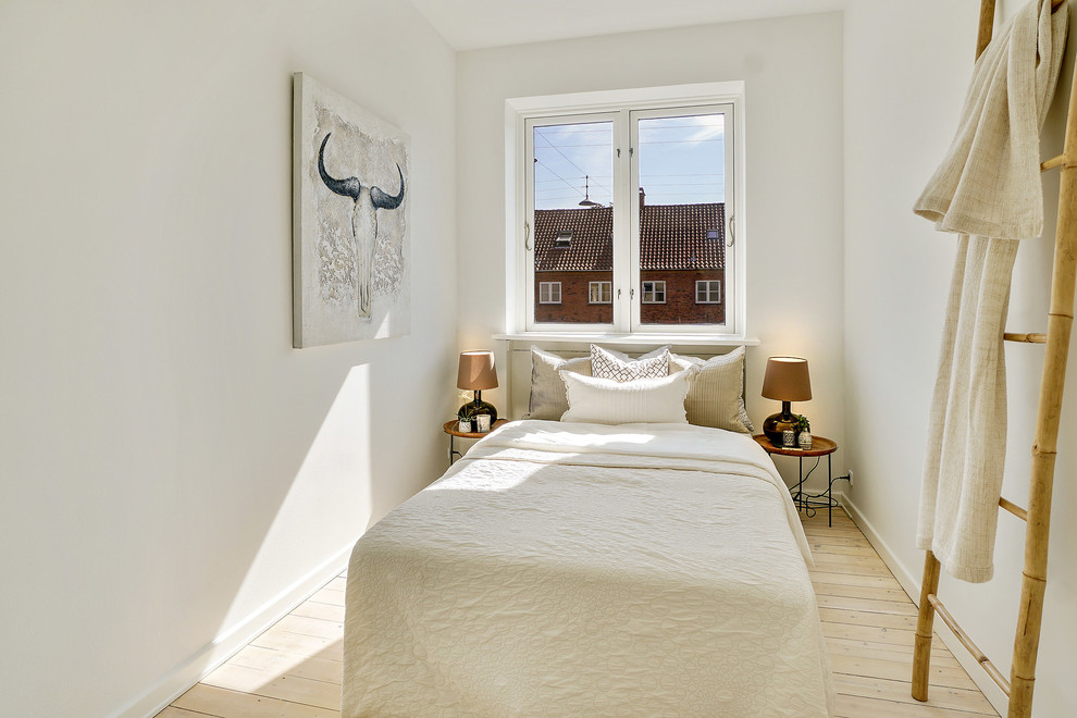 Danish guest light wood floor and beige floor bedroom photo in Copenhagen with white walls