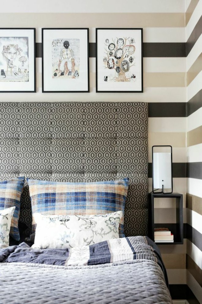 Inspiration for a modern bedroom in Copenhagen with multi-coloured walls and medium hardwood flooring.