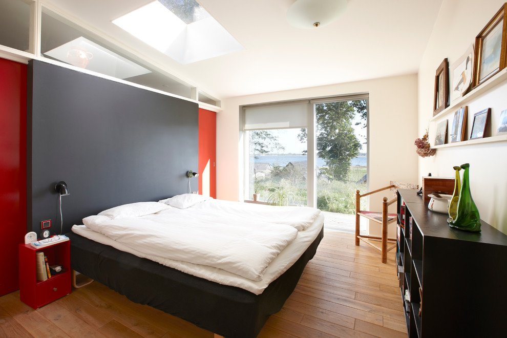 Bedroom - mid-sized contemporary master medium tone wood floor bedroom idea in Esbjerg with white walls and no fireplace