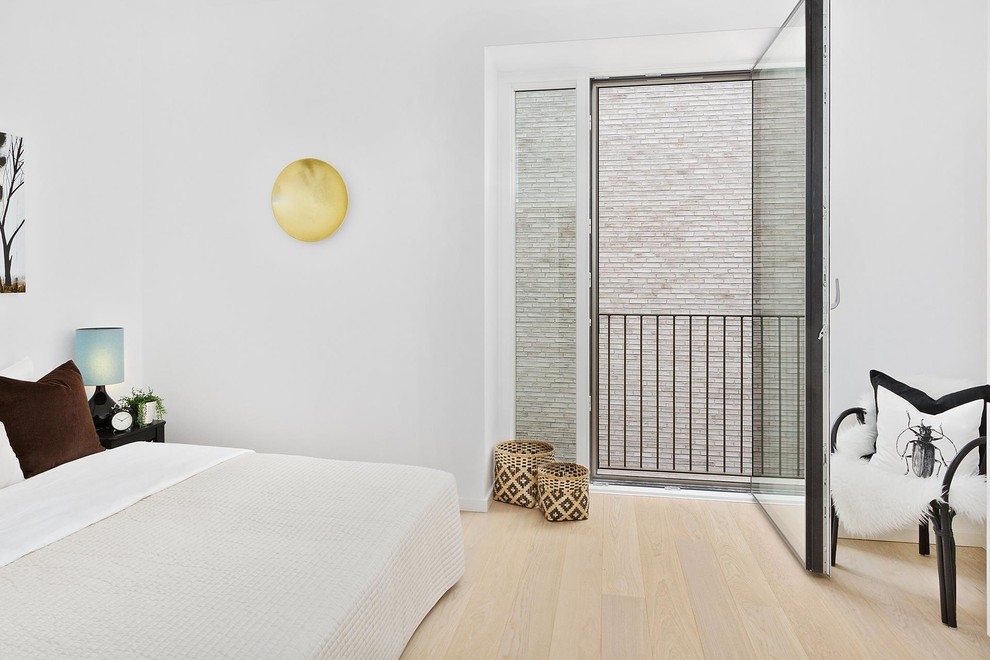 Inspiration for a scandinavian guest light wood floor and beige floor bedroom remodel in Copenhagen with white walls