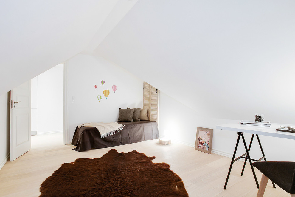 This is an example of a medium sized scandi master bedroom in Aarhus with white walls, light hardwood flooring and no fireplace.