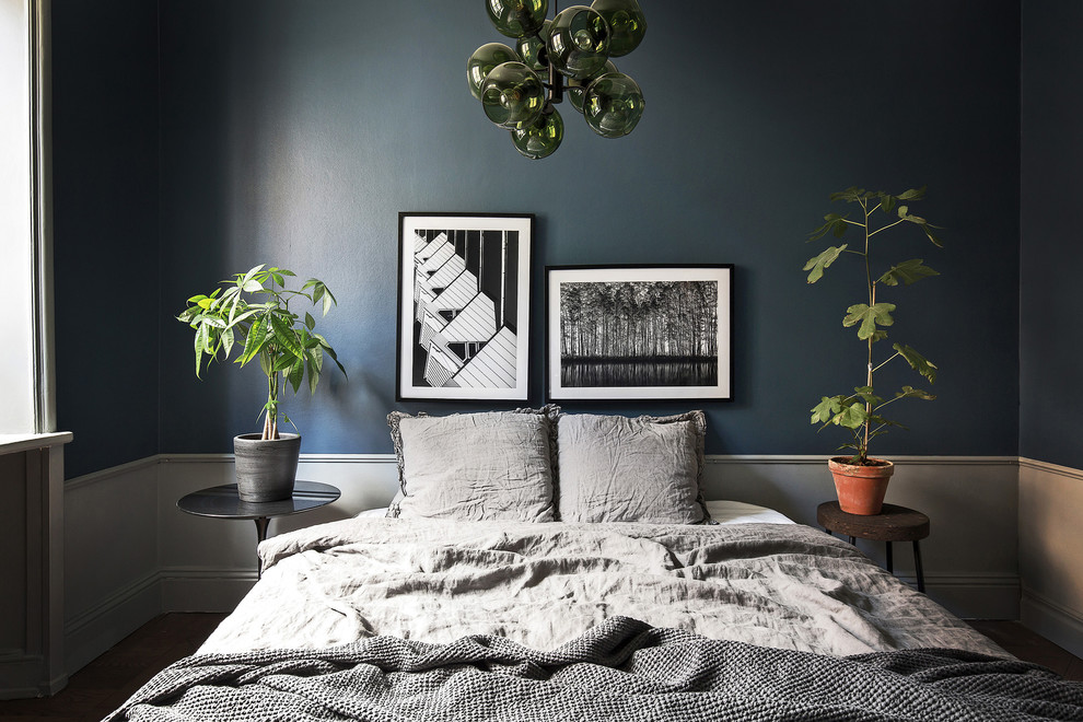 Example of a small danish master dark wood floor bedroom design in Stockholm with no fireplace and blue walls
