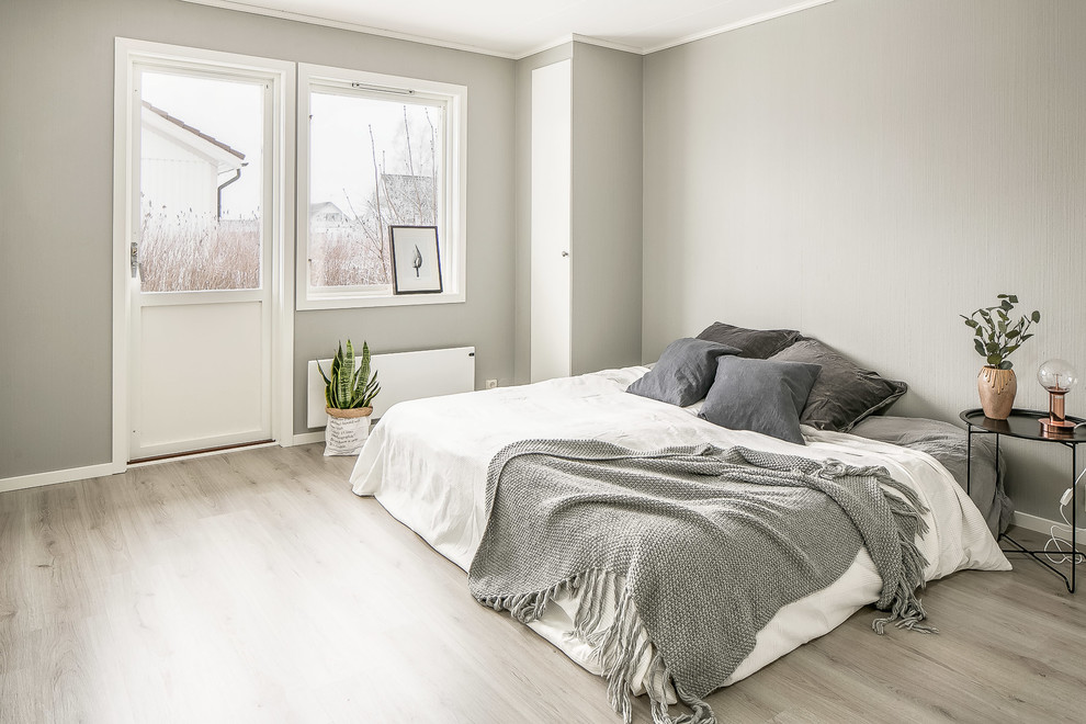 Photo of a scandi bedroom in Other with grey walls, no fireplace and grey floors.