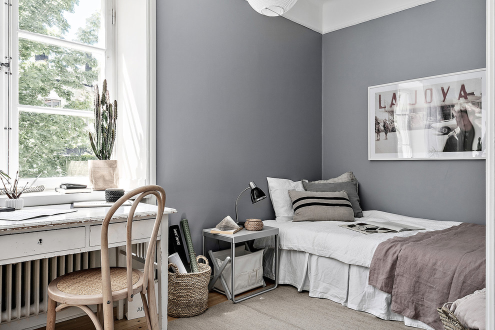 Example of a mid-sized danish guest bedroom design in Stockholm with gray walls and no fireplace