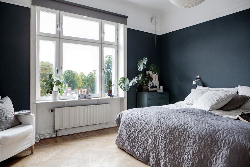 Inspiration för nordiska sovrum, med ljust trägolv, beiget golv och svarta väggar