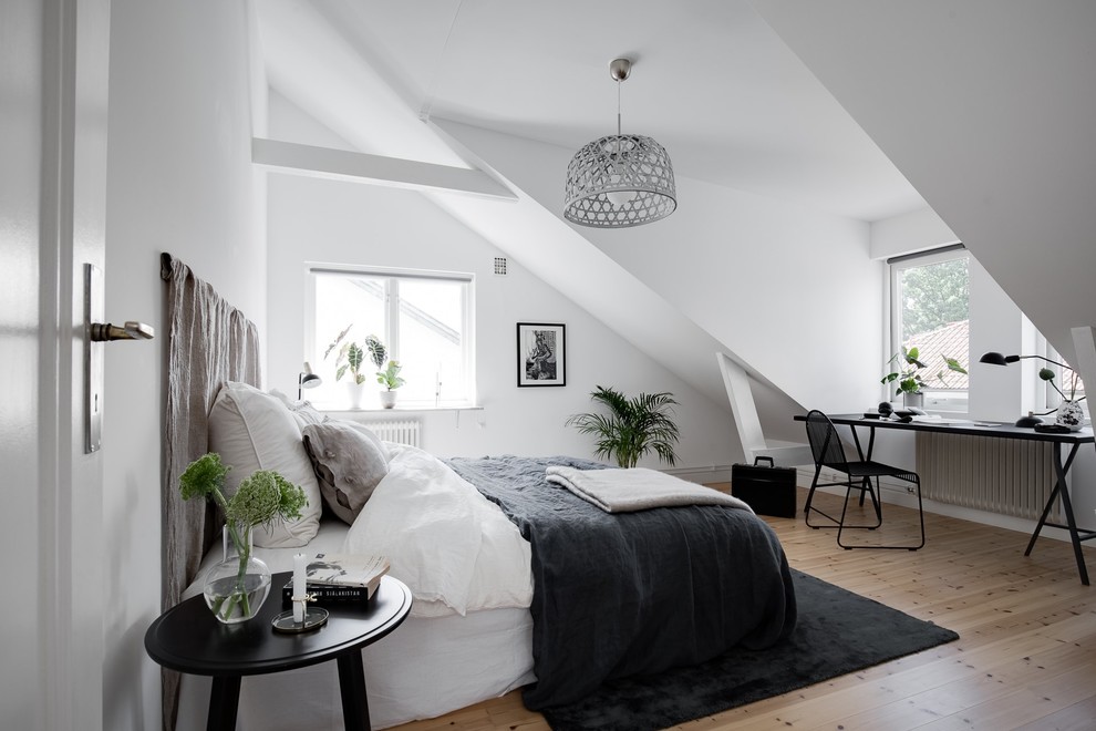 Inspiration for a medium sized scandi guest bedroom in Gothenburg with white walls, light hardwood flooring and beige floors.