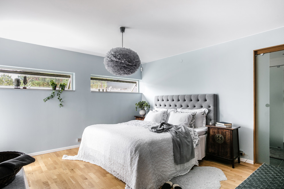Inspiration för mellanstora moderna sovrum, med grå väggar, mellanmörkt trägolv och brunt golv