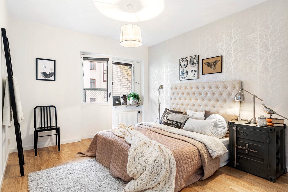 Inspiration for a medium sized classic master bedroom in Gothenburg with white walls, medium hardwood flooring, no fireplace and a feature wall.