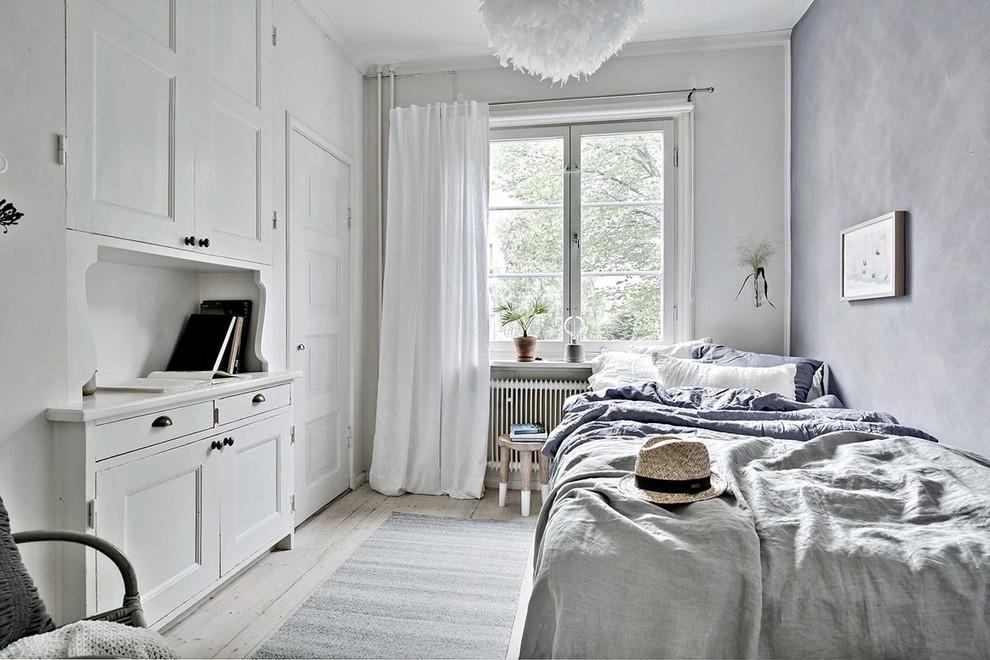 This is an example of a medium sized scandinavian master bedroom in Gothenburg with grey walls, light hardwood flooring and no fireplace.