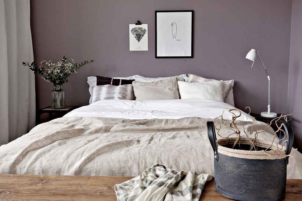 Cette image montre une chambre parentale nordique avec un mur violet.