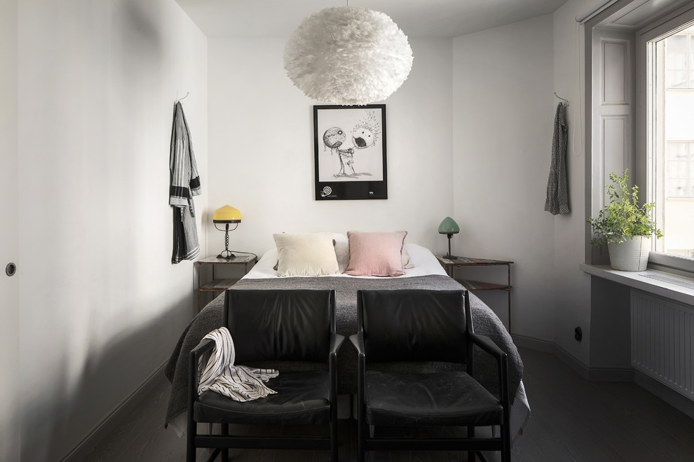 Design ideas for a small scandi guest bedroom in Stockholm with white walls and dark hardwood flooring.