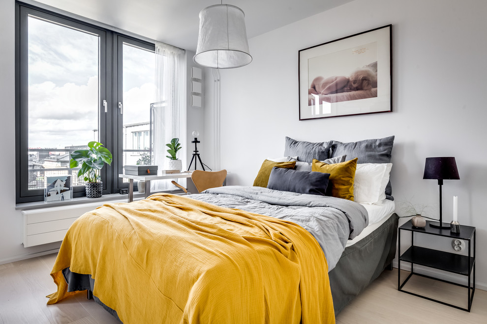 Photo of a scandi master and grey and yellow bedroom in Stockholm with white walls, no fireplace and beige floors.