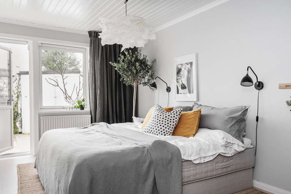 Photo of a medium sized scandi master bedroom in Gothenburg with grey walls, no fireplace and beige floors.