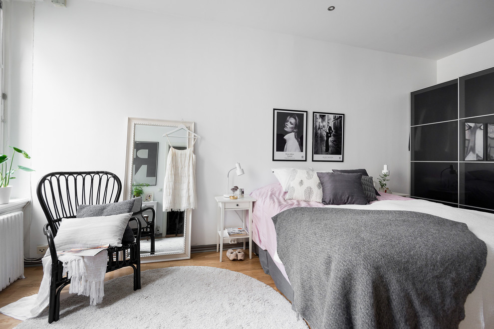 Стильный дизайн: большая хозяйская спальня в скандинавском стиле с белыми стенами и паркетным полом среднего тона - последний тренд