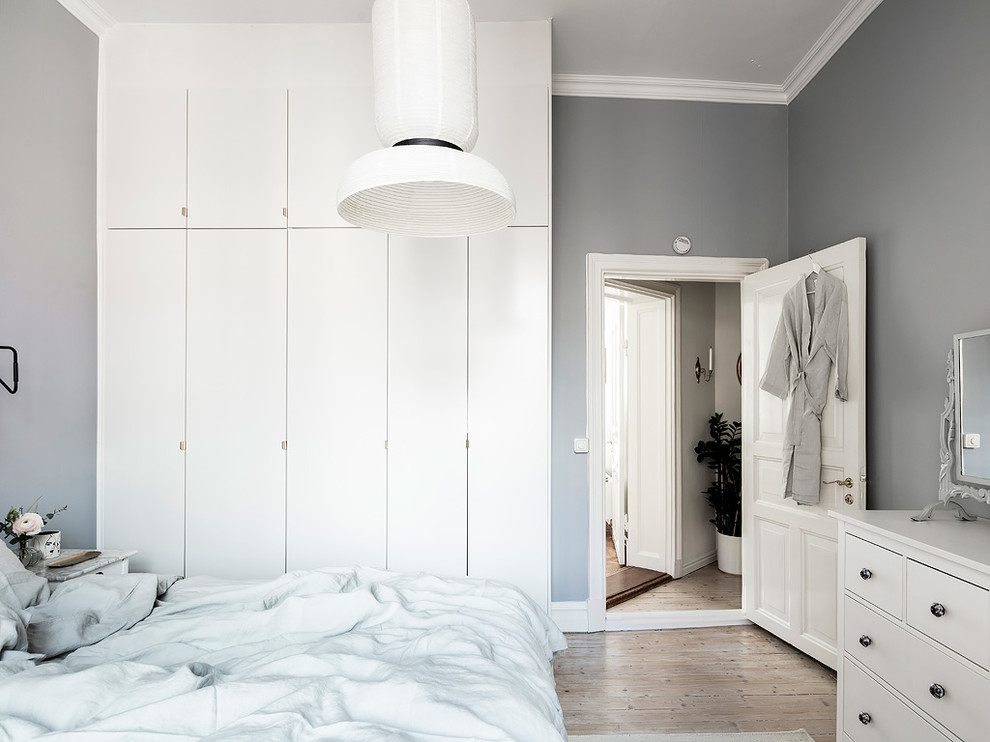 Inspiration for a scandi bedroom in Gothenburg with grey walls and medium hardwood flooring.