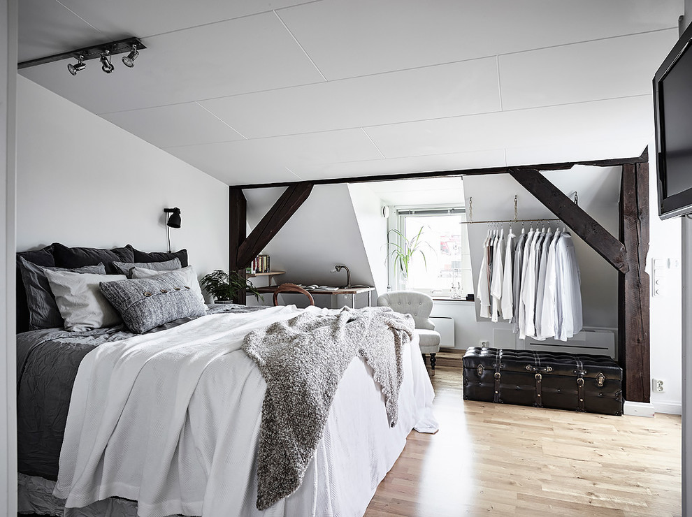 Danish light wood floor and beige floor bedroom photo in Gothenburg with white walls