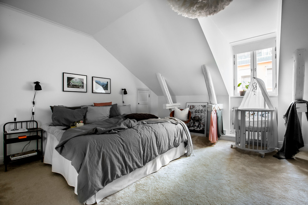 This is an example of a large scandinavian master bedroom in Stockholm with white walls, carpet and beige floors.