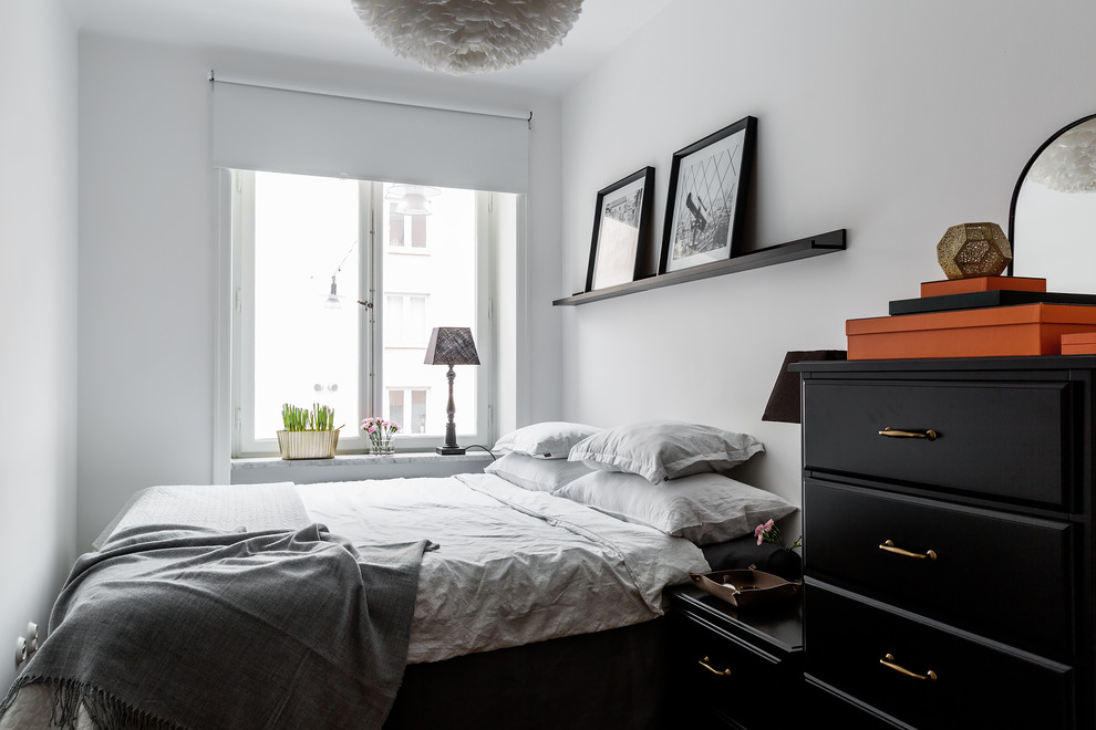 Example of a small danish master bedroom design in Stockholm with white walls