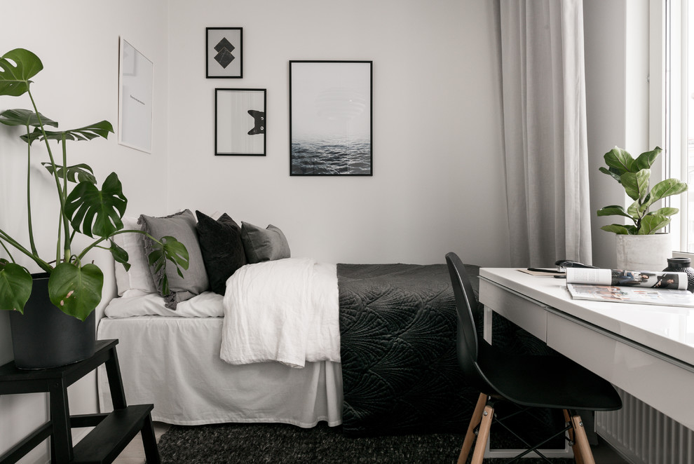This is an example of a small scandinavian guest bedroom in Stockholm with white walls.