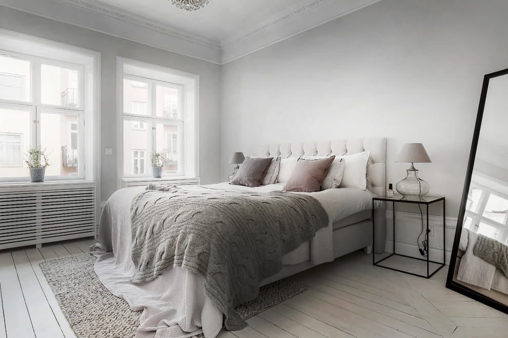 Design ideas for a medium sized scandi master bedroom in Stockholm with white walls, light hardwood flooring and no fireplace.