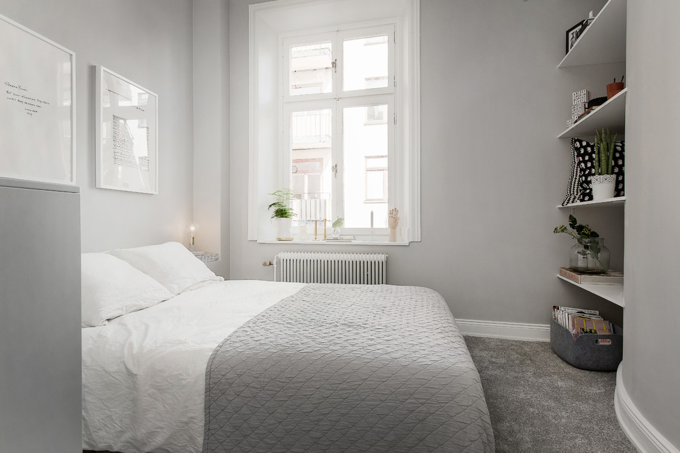 На фото: хозяйская спальня среднего размера в скандинавском стиле с белыми стенами и ковровым покрытием
