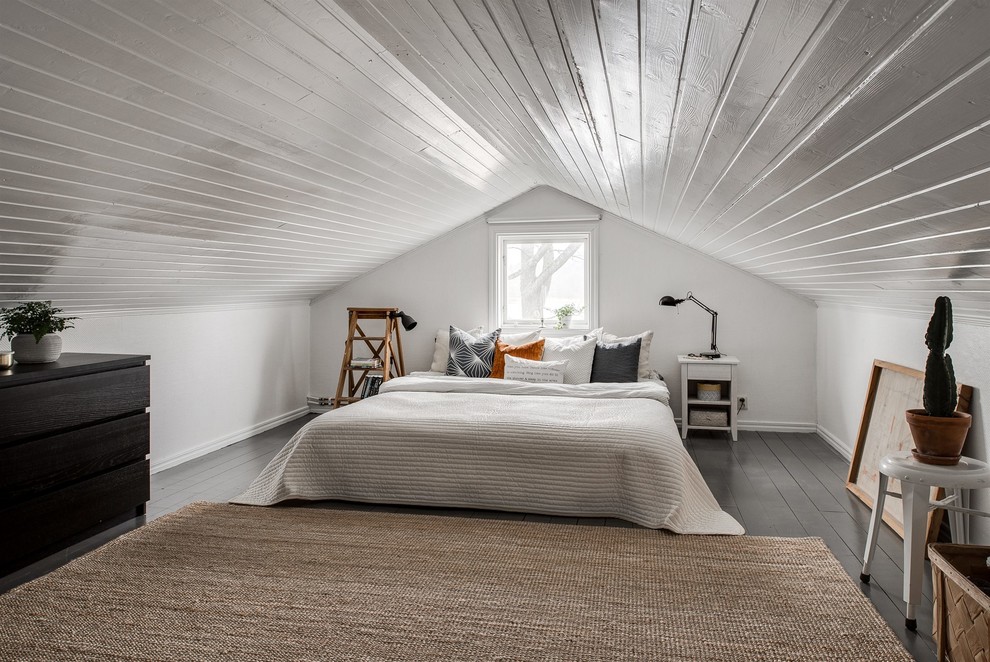 Photo of a scandi master bedroom in Gothenburg with white walls, no fireplace and black floors.