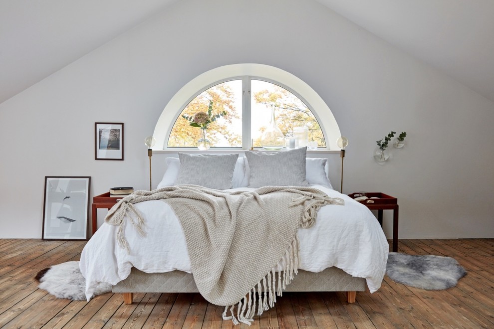 Mittelgroßes Nordisches Hauptschlafzimmer ohne Kamin mit weißer Wandfarbe und braunem Holzboden in Göteborg