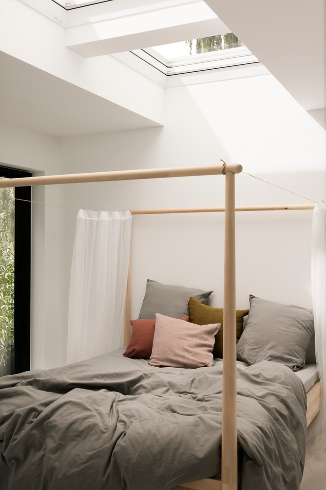 This is an example of a scandi bedroom in Malmo with white walls.