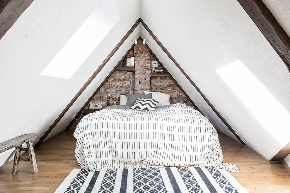Example of a mid-sized danish master light wood floor bedroom design in Gothenburg with white walls