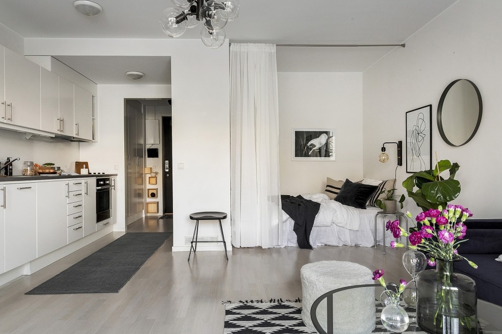 Inspiration för skandinaviska sovrum, med vita väggar och grått golv