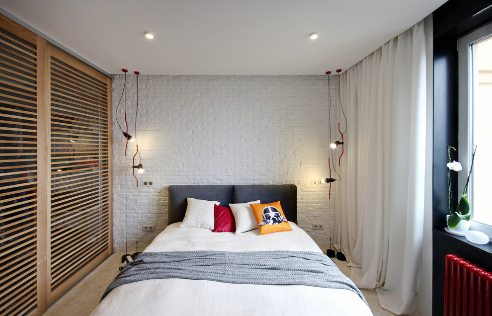 Contemporary bedroom in Other with white walls and carpet.
