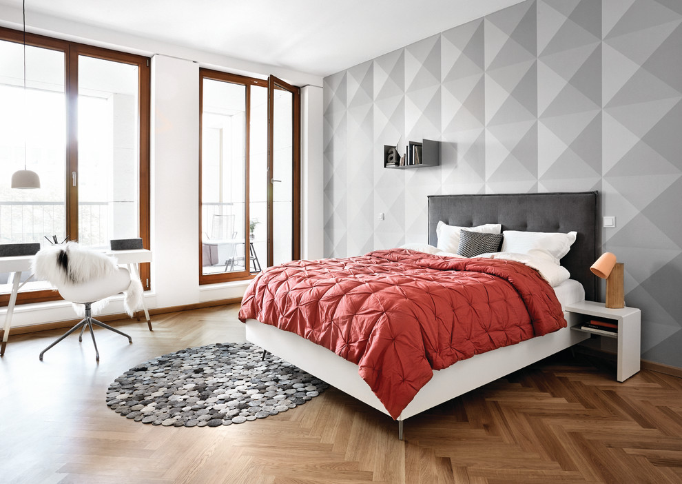 Idee per una camera matrimoniale scandinava con pavimento in legno massello medio e pareti grigie