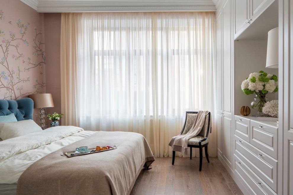 This is an example of a medium sized master bedroom in Moscow with medium hardwood flooring.