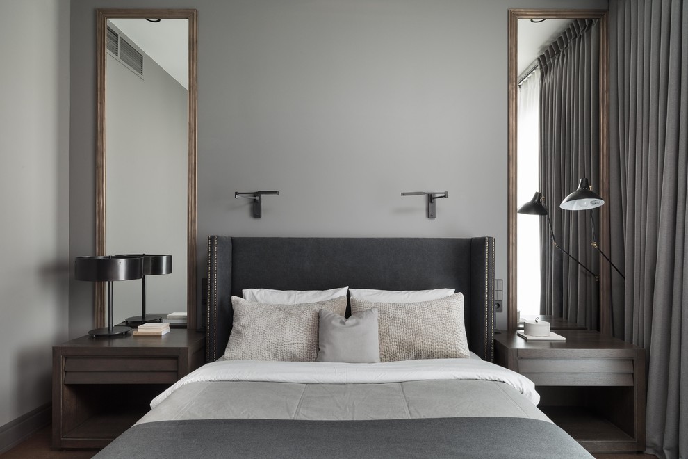 Design ideas for a contemporary master bedroom in Moscow with grey walls, no fireplace and feature lighting.