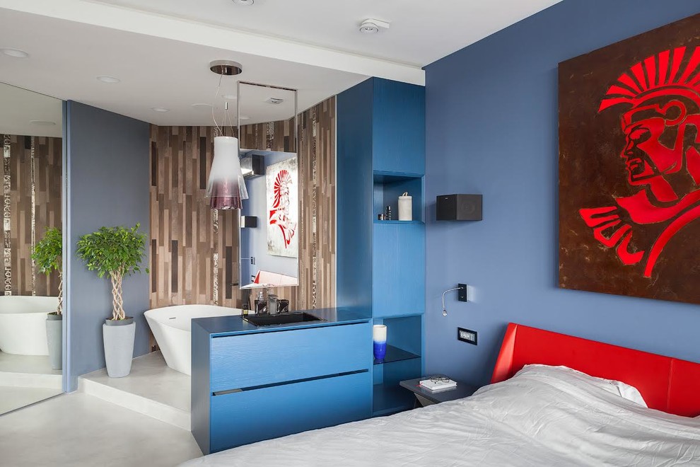 Diseño de dormitorio principal actual con paredes azules, suelo gris y suelo de cemento