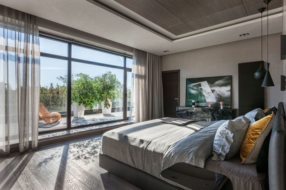 Contemporary master bedroom in Moscow with grey walls, medium hardwood flooring and grey floors.