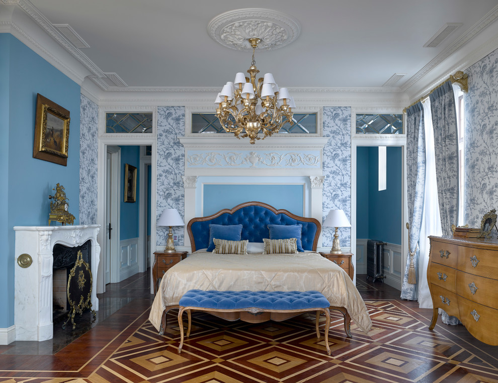 Klassisches Hauptschlafzimmer mit blauer Wandfarbe, Kamin und buntem Boden in Moskau