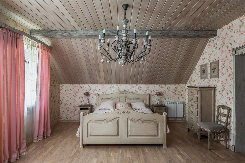 Vintage guest loft bedroom in Other with light hardwood flooring and pink walls.