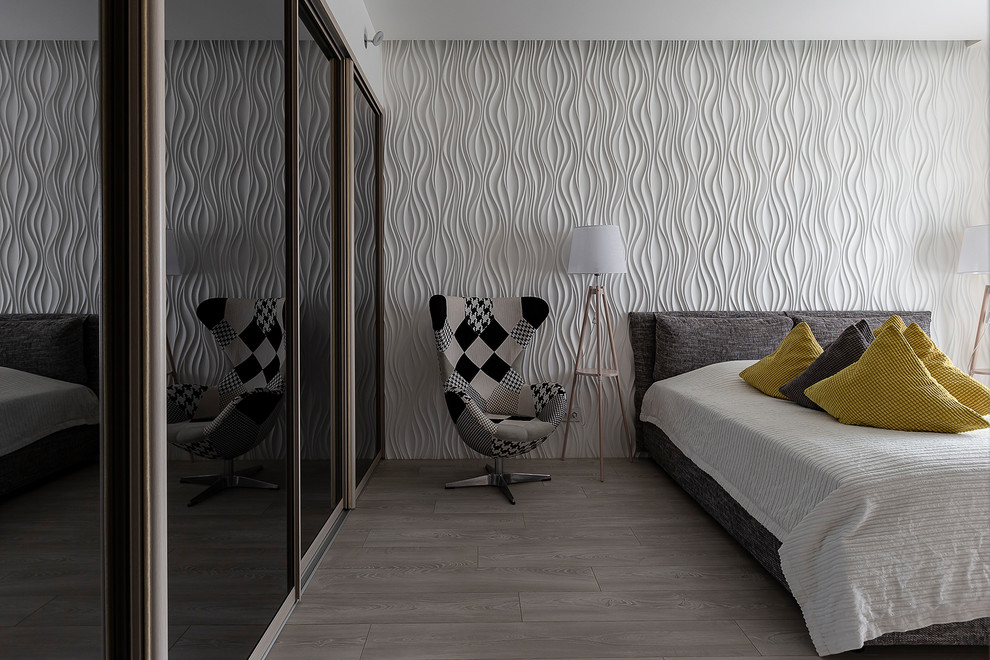 Ispirazione per una camera degli ospiti minimal di medie dimensioni con pareti bianche, pavimento in laminato e pavimento grigio
