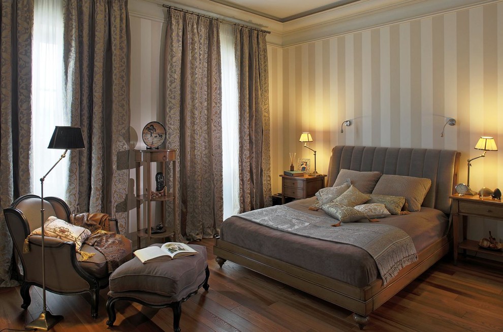 Traditional master bedroom in Moscow with medium hardwood flooring, multi-coloured walls and feature lighting.