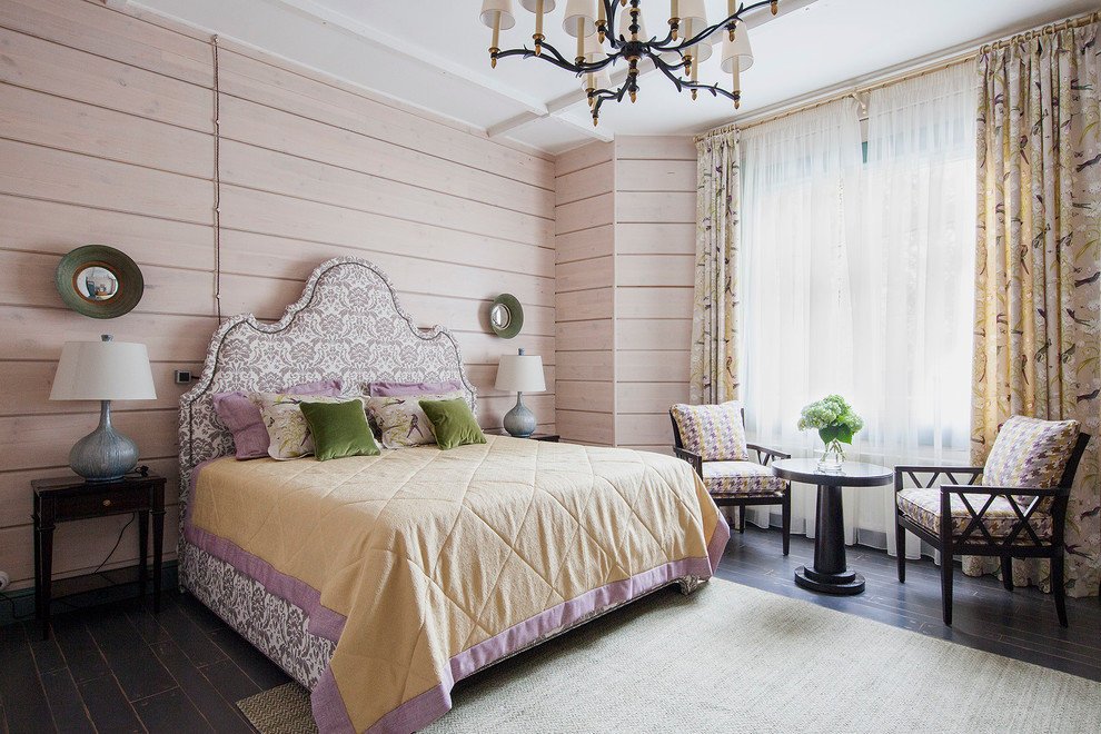 Traditional bedroom in Moscow with beige walls and dark hardwood flooring.