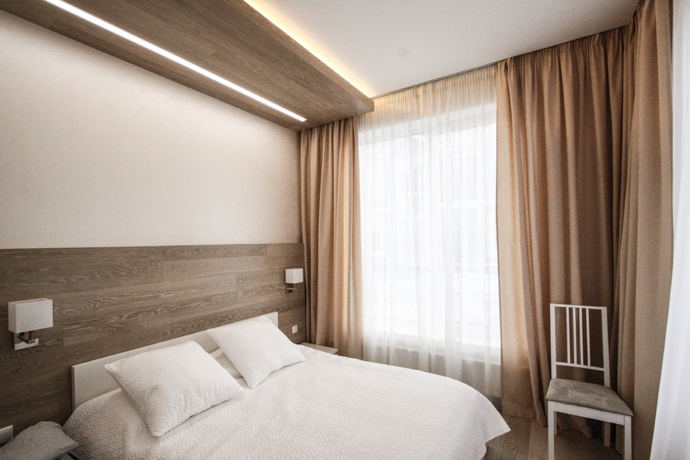 Photo of a small scandi guest bedroom in Moscow with beige walls, medium hardwood flooring and beige floors.