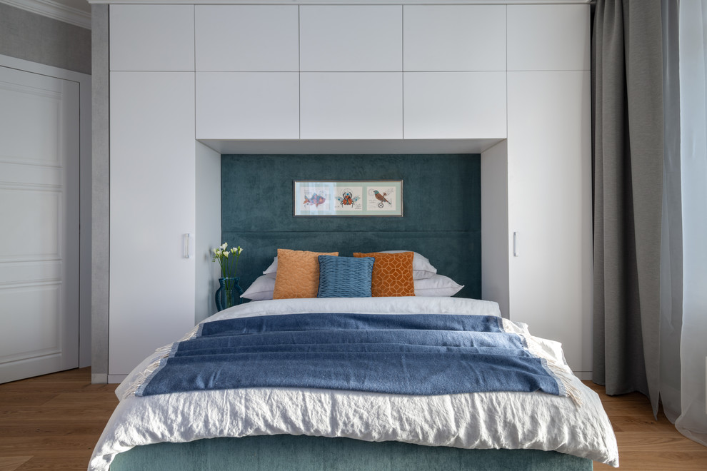 Photo of a contemporary master and grey and brown bedroom in Moscow with medium hardwood flooring, brown floors and grey walls.