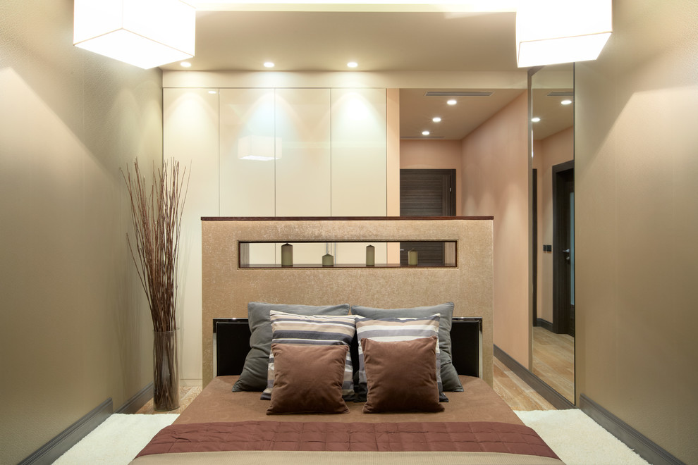 Photo of a medium sized contemporary master bedroom in Moscow with beige walls and carpet.