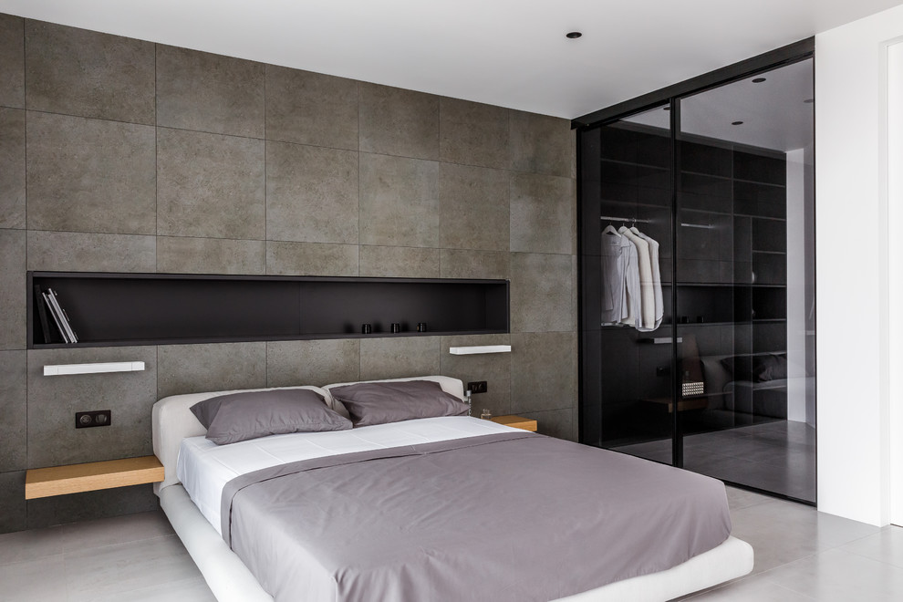 Пример оригинального дизайна: хозяйская спальня в современном стиле с серыми стенами и серым полом без камина