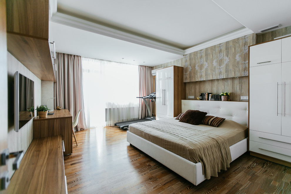 Large contemporary guest bedroom in Moscow with beige walls, medium hardwood flooring and brown floors.