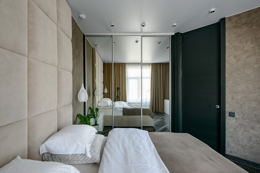 Imagen de dormitorio principal actual grande con paredes marrones, suelo de madera oscura y suelo negro