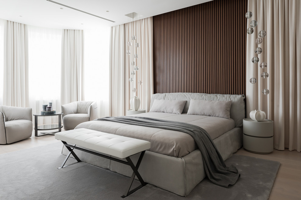Example of a trendy light wood floor and beige floor bedroom design in Moscow