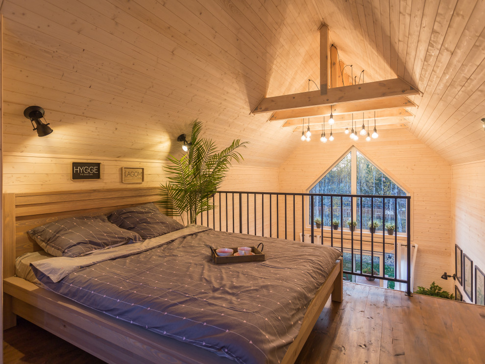Immagine di una piccola camera matrimoniale nordica con pareti bianche e pavimento marrone